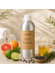 EcoPlanet® Detoxifying Body Massage Oil displayed in a calm spa setting with citrus fruits, juniper berries and natural herbs.